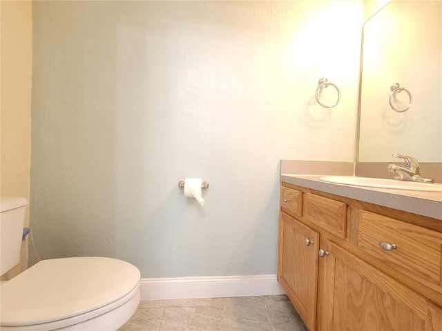 bathroom featuring tile patterned flooring, vanity, and toilet