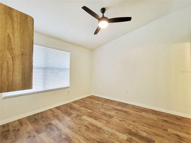 spare room featuring wood-type flooring, ceiling fan, and lofted ceiling