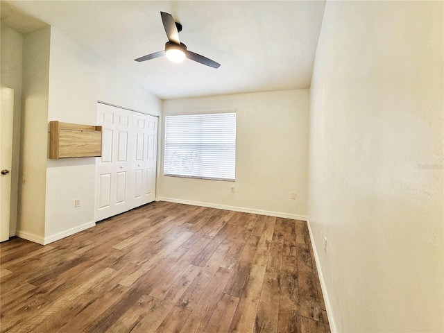 unfurnished bedroom featuring a closet, ceiling fan, and hardwood / wood-style floors