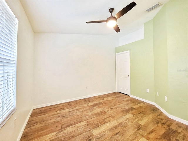 spare room with ceiling fan, light hardwood / wood-style floors, and lofted ceiling