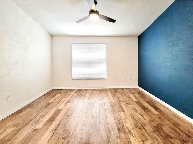 spare room featuring light hardwood / wood-style flooring and ceiling fan