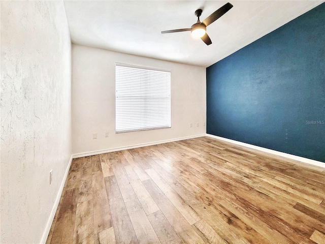 unfurnished room with ceiling fan and light hardwood / wood-style floors