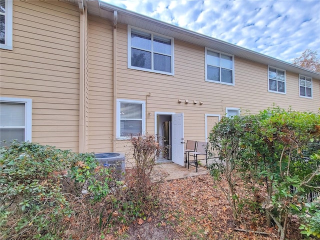 rear view of property featuring cooling unit and a patio