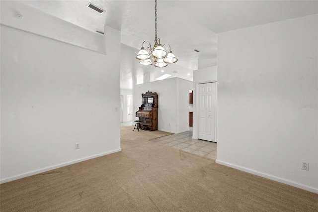 unfurnished living room with light colored carpet, vaulted ceiling, and a notable chandelier