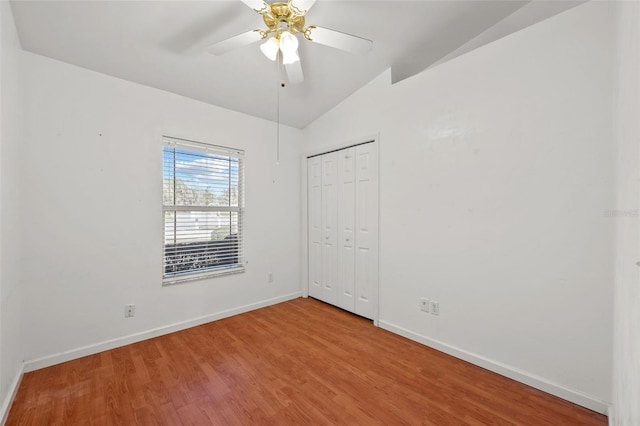 spare room featuring hardwood / wood-style floors, ceiling fan, and lofted ceiling