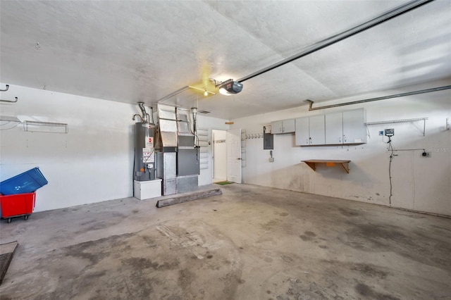 garage featuring electric panel, water heater, and a garage door opener