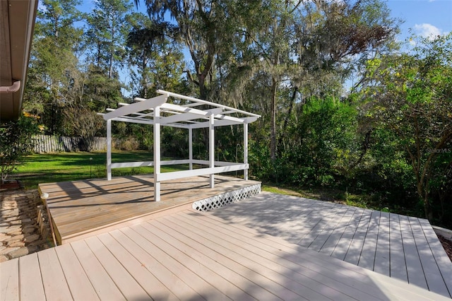 deck featuring a pergola and a yard