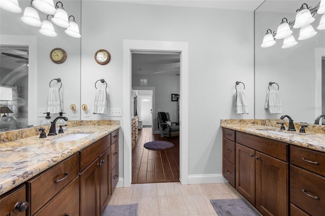 bathroom with tile patterned floors, ceiling fan, and vanity