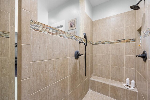 bathroom with a tile shower