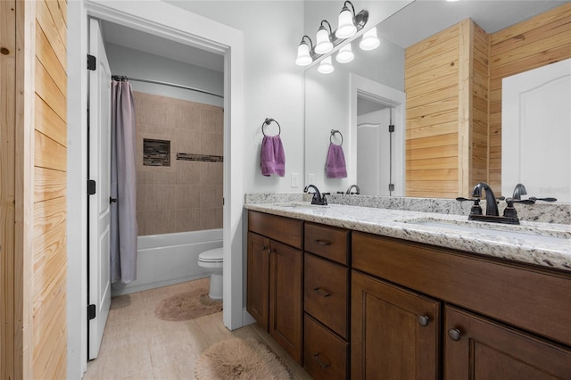 full bathroom with vanity, shower / bathtub combination with curtain, and toilet