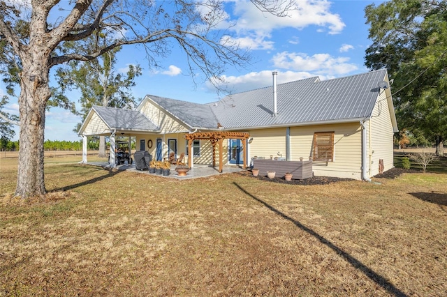 back of property with a lawn, a pergola, and a patio area