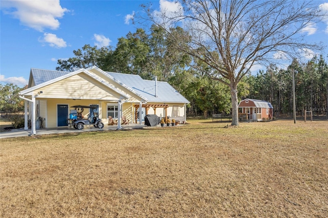 exterior space with an outbuilding, a carport, and a lawn