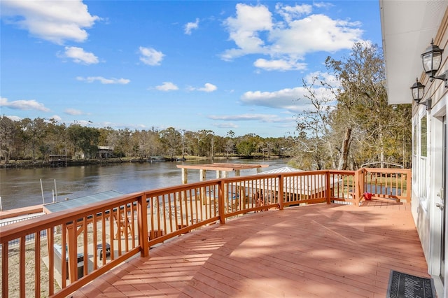 wooden terrace featuring a water view