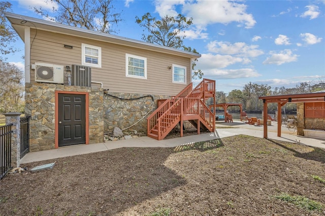 back of house with a patio area and ac unit