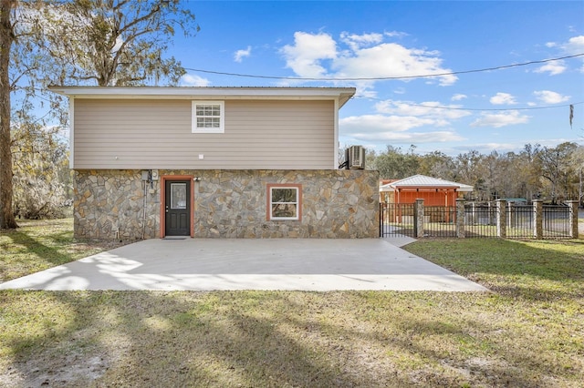 back of property with a yard and a patio