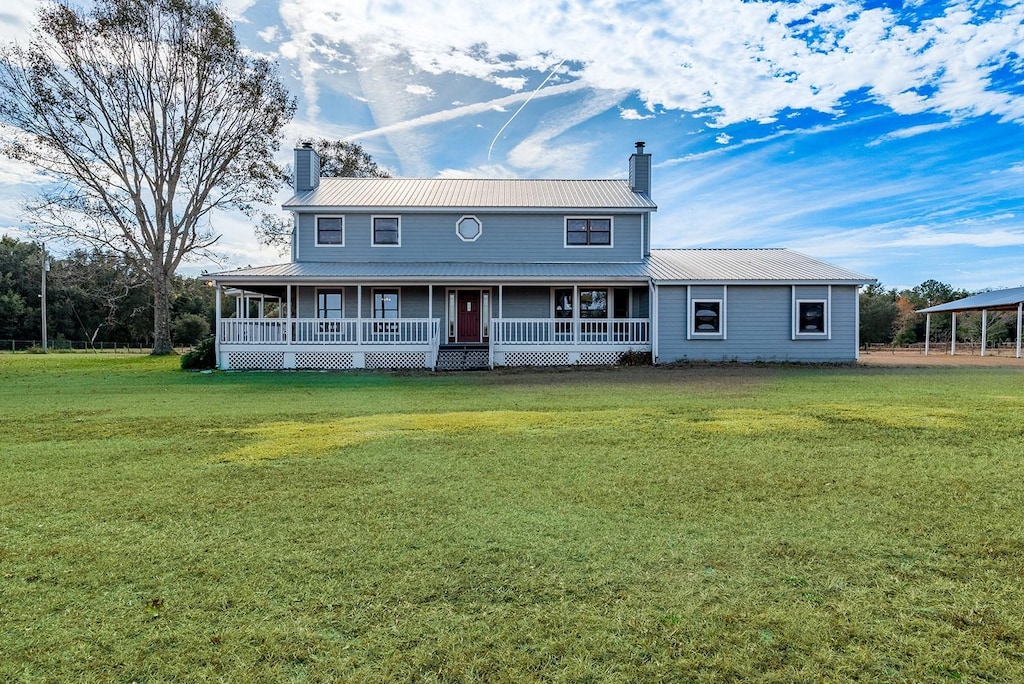 country-style home featuring a front yard and a porch