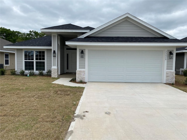 view of front of house with a front lawn and a garage