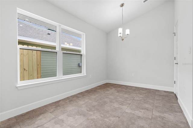 spare room featuring a notable chandelier and light tile patterned floors