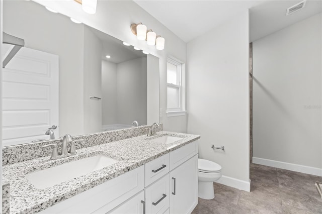 bathroom with vanity and toilet