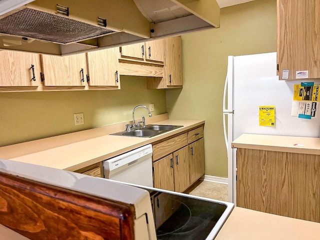 kitchen featuring light brown cabinetry, dishwasher, and sink