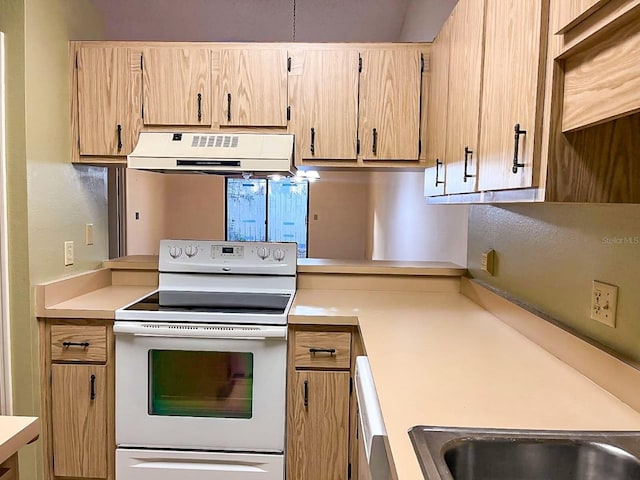 kitchen featuring white range with electric stovetop and light brown cabinets