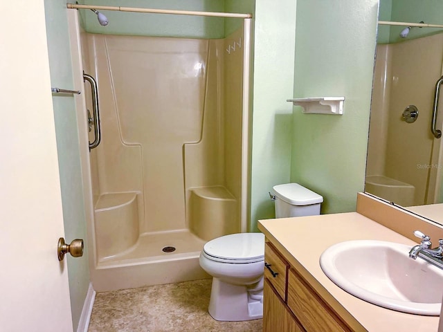 bathroom with vanity, toilet, and walk in shower