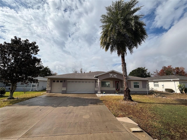 single story home with a garage and a front lawn