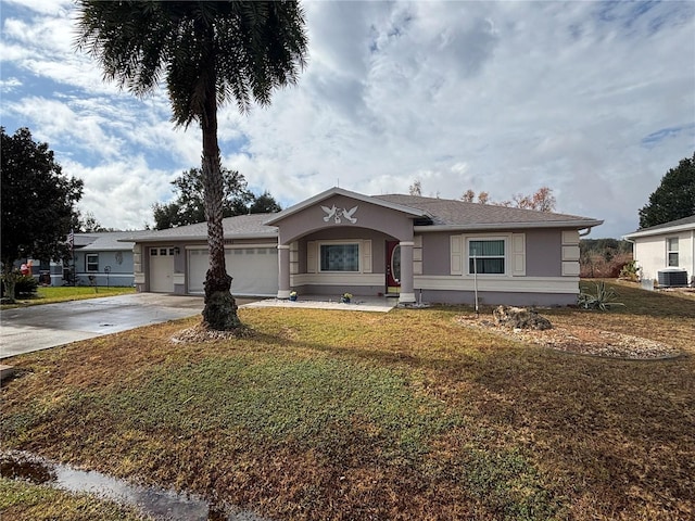 ranch-style house with central AC, a garage, and a front lawn