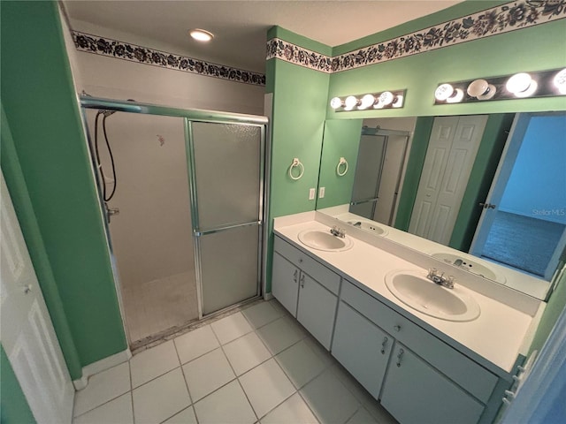 bathroom with tile patterned flooring, vanity, and walk in shower