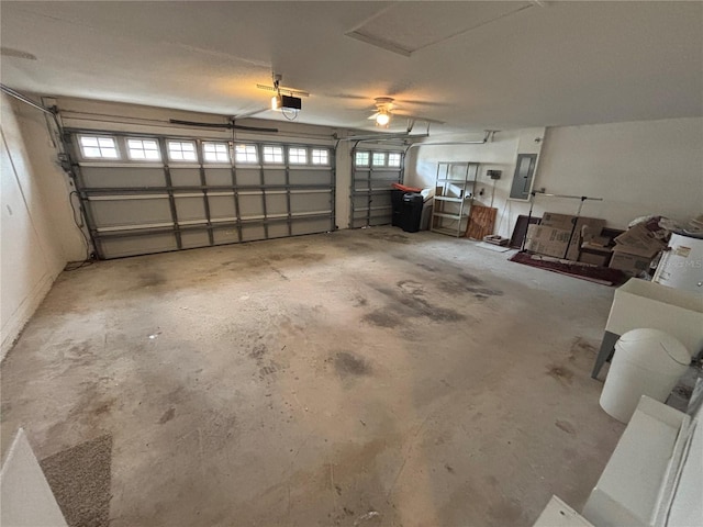 garage with electric panel and a garage door opener