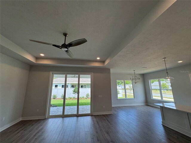 804 SW 144th Dr, Newberry, FL 32669 - unfurnished room featuring a chandelier, dark wood finished floors, a ceiling fan, a tray ceiling, and recessed lighting