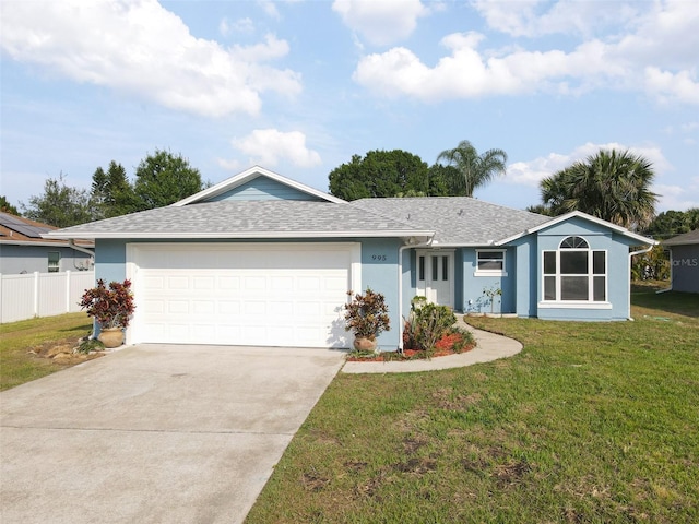 single story home with a garage and a front lawn