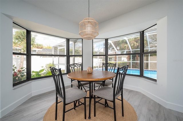 dining space with an inviting chandelier and light wood-type flooring