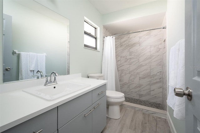 bathroom with vanity, hardwood / wood-style floors, a shower with shower curtain, and toilet