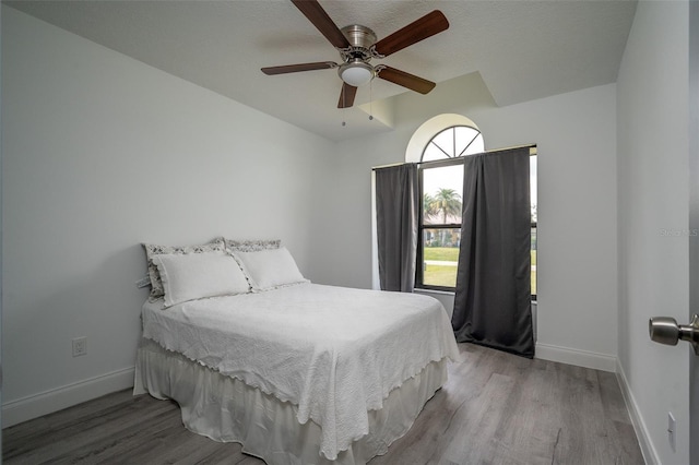 bedroom with ceiling fan and light hardwood / wood-style floors