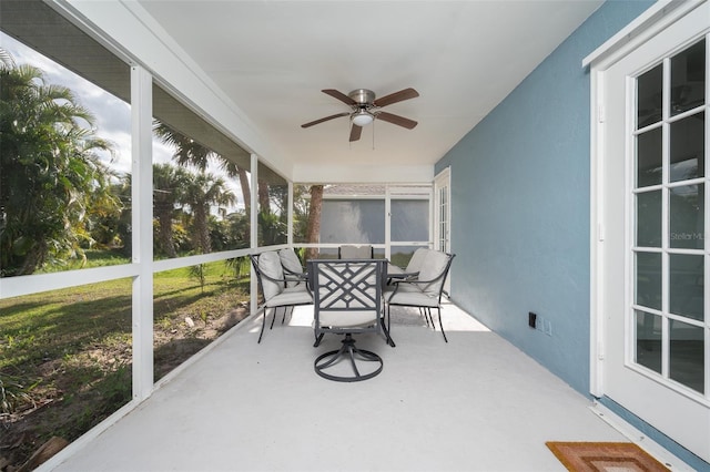 sunroom featuring ceiling fan