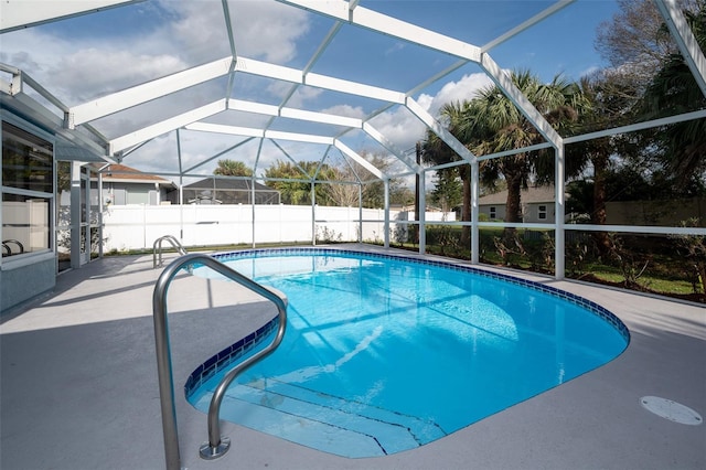 view of swimming pool with a patio and glass enclosure