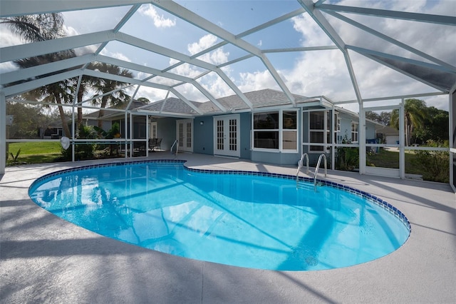 view of pool featuring a lanai, a patio area, and french doors