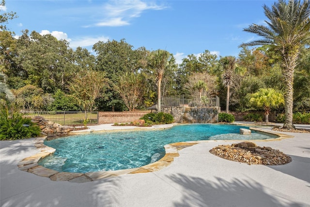 view of pool with pool water feature and a patio