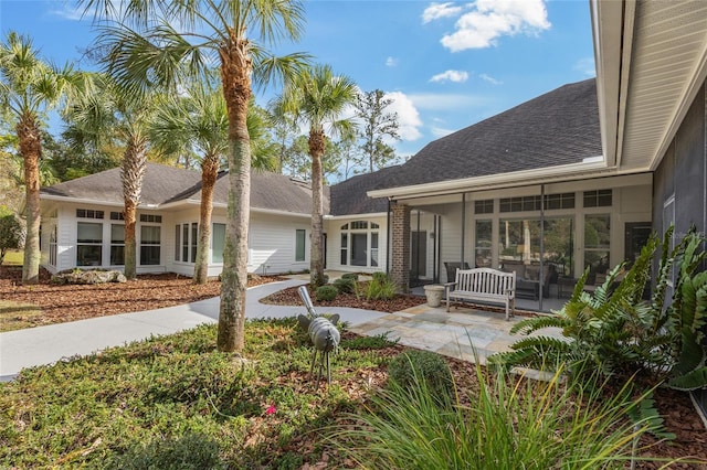 back of property with a patio