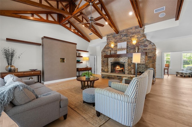 7106 NW 18th Ave, Gainesville, FL 32605 - living room with high vaulted ceiling, light wood-style floors, visible vents, a ceiling fan, and a fireplace