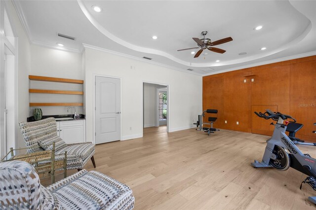 7106 NW 18th Ave, Gainesville, FL 32605 - exercise room with a sink, a raised ceiling, light wood finished floors, ceiling fan, and ornamental molding