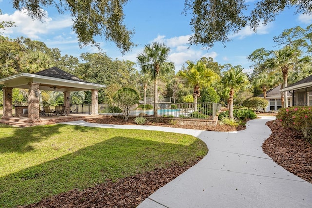 7106 NW 18th Ave, Gainesville, FL 32605 - view of home's community with a lawn, fence, and a patio area