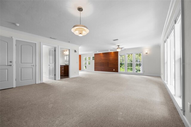7106 NW 18th Ave, Gainesville, FL 32605 - unfurnished living room featuring ornamental molding, a ceiling fan, carpet, and plenty of natural light