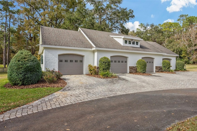 7106 NW 18th Ave, Gainesville, FL 32605 - view of front of house with decorative driveway, roof with shingles, and an attached garage