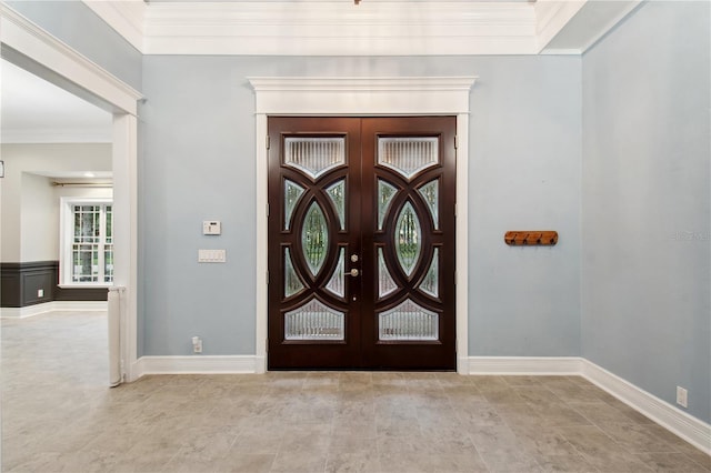 entryway featuring french doors and crown molding