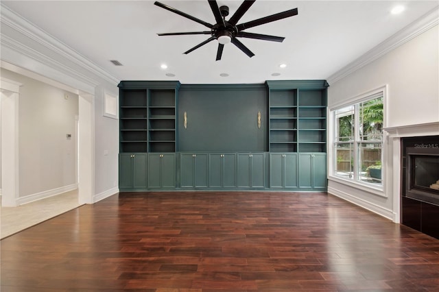 unfurnished living room with dark hardwood / wood-style flooring, ceiling fan, and crown molding