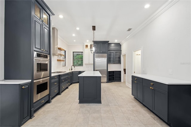 kitchen with decorative light fixtures, a center island, ornamental molding, and stainless steel appliances