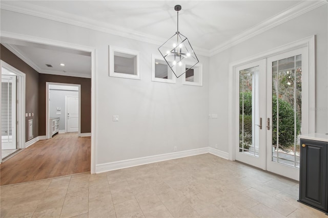 unfurnished dining area with light hardwood / wood-style floors, an inviting chandelier, crown molding, and french doors