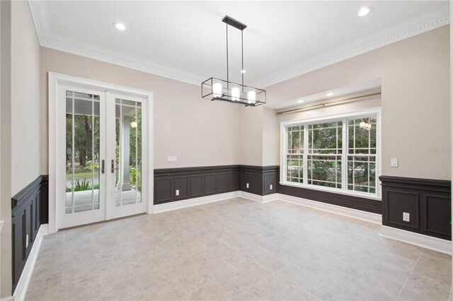 empty room with french doors, plenty of natural light, and crown molding